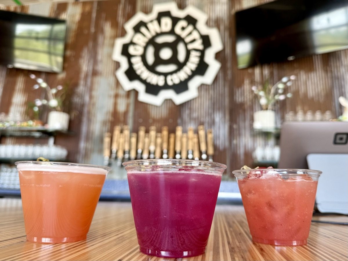 A colorful row of party drinks on a mobile bar