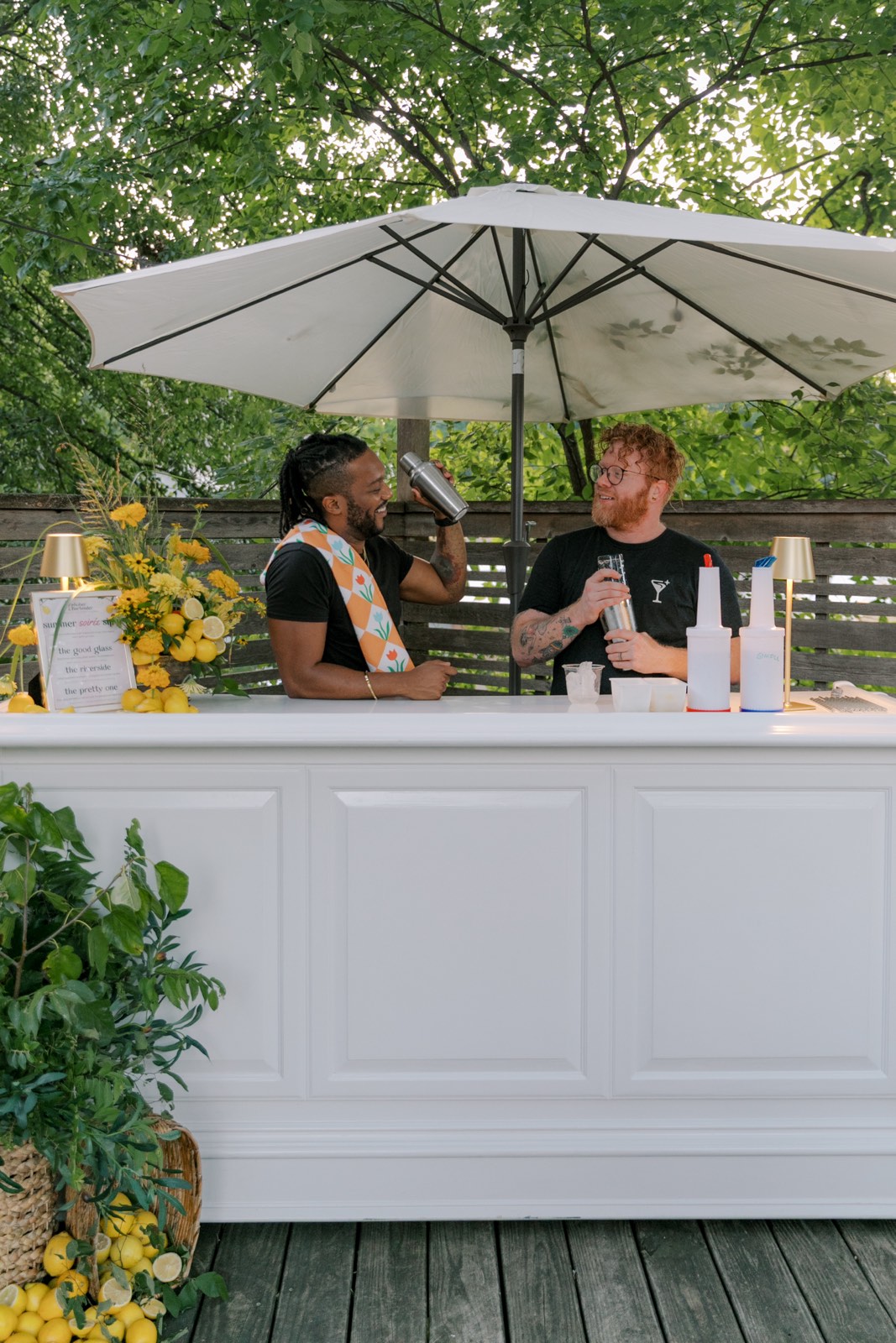 The bar set up under a patio umbrella at an event