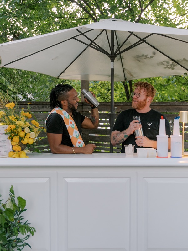 The bar set up under a patio umbrella